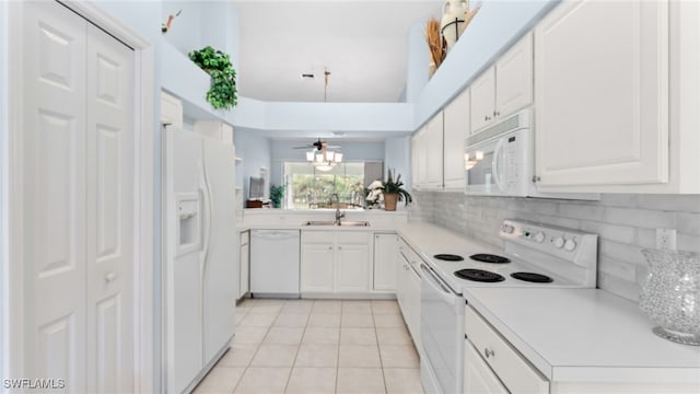 kitchen featuring tasteful backsplash, white appliances, ceiling fan, light tile patterned floors, and white cabinets