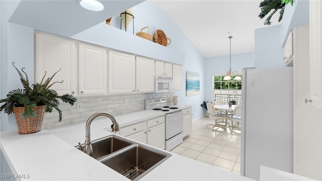 kitchen featuring sink, pendant lighting, white appliances, decorative backsplash, and white cabinets