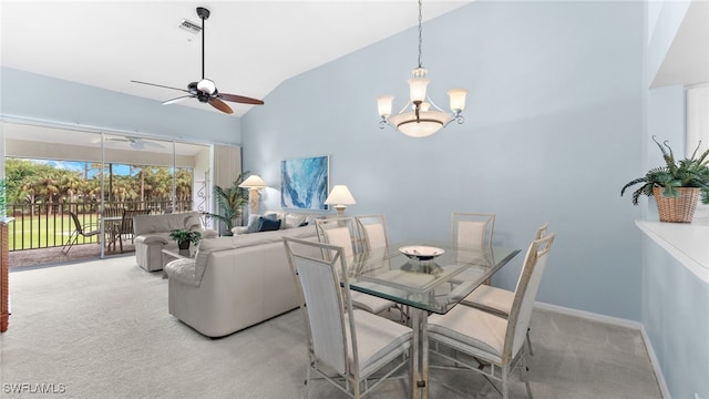 dining space with light carpet, ceiling fan with notable chandelier, and lofted ceiling