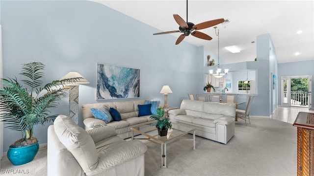 living room featuring ceiling fan with notable chandelier, lofted ceiling, and light carpet