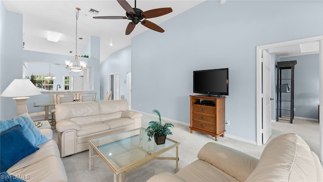 living room featuring high vaulted ceiling, light colored carpet, and ceiling fan with notable chandelier