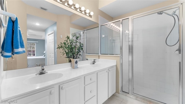 bathroom featuring tile patterned floors, vanity, and an enclosed shower