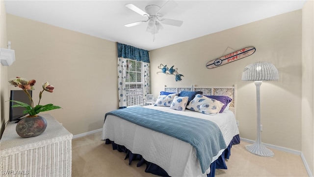 bedroom featuring ceiling fan and light colored carpet