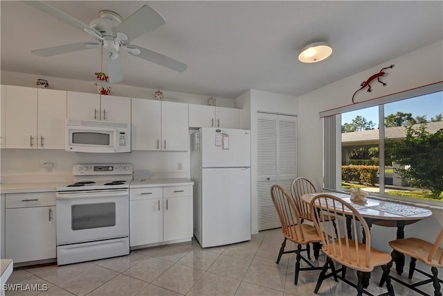 kitchen with white cabinetry, light tile patterned floors, white appliances, and ceiling fan