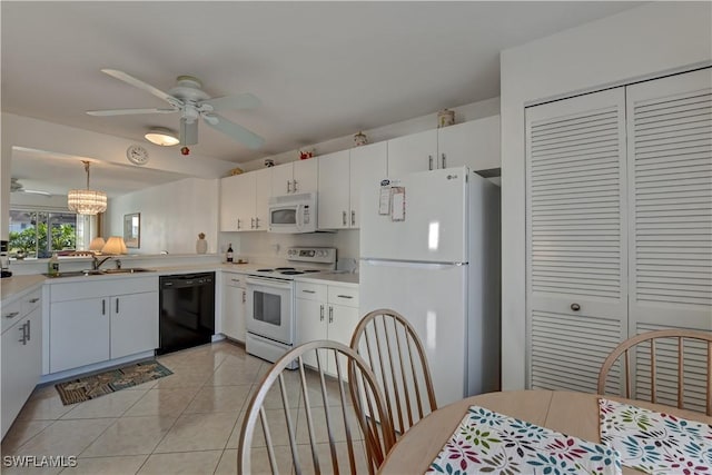 kitchen featuring white cabinets, white appliances, ceiling fan with notable chandelier, and hanging light fixtures