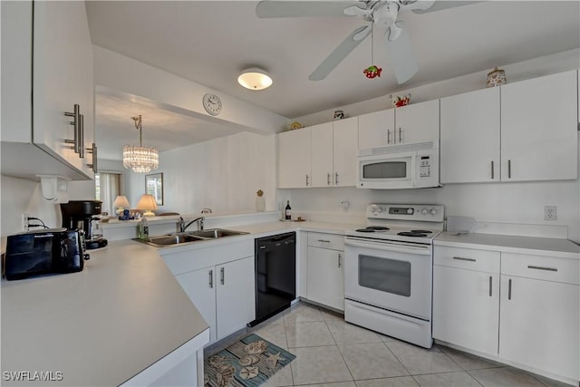 kitchen featuring sink, white cabinets, decorative light fixtures, and white appliances