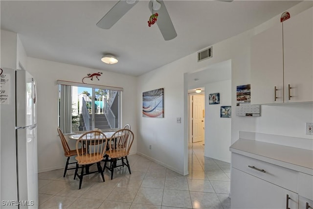 dining room with light tile patterned floors and ceiling fan