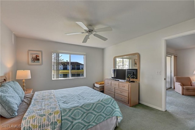 bedroom featuring ceiling fan, light carpet, and multiple windows