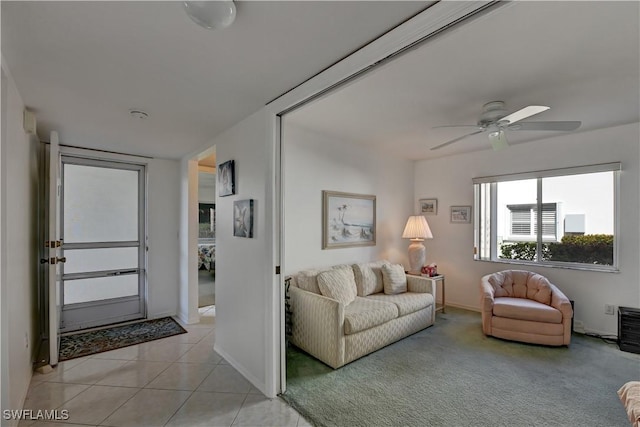 living room with ceiling fan and light tile patterned flooring