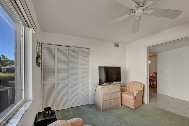 living room featuring tile patterned flooring and ceiling fan