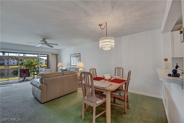 dining area with ceiling fan with notable chandelier and carpet floors