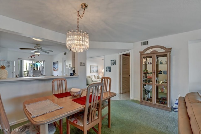 dining area with light carpet and ceiling fan with notable chandelier