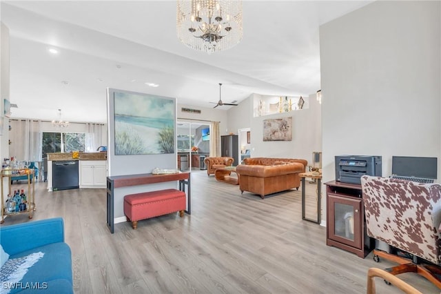 living room featuring light hardwood / wood-style floors, lofted ceiling, and a notable chandelier