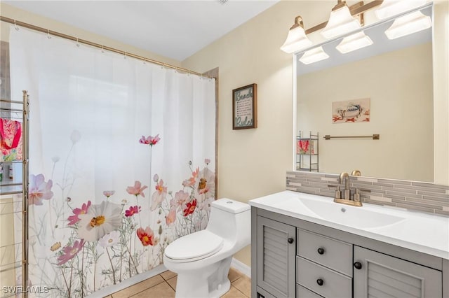 bathroom with tile patterned floors, vanity, toilet, and backsplash