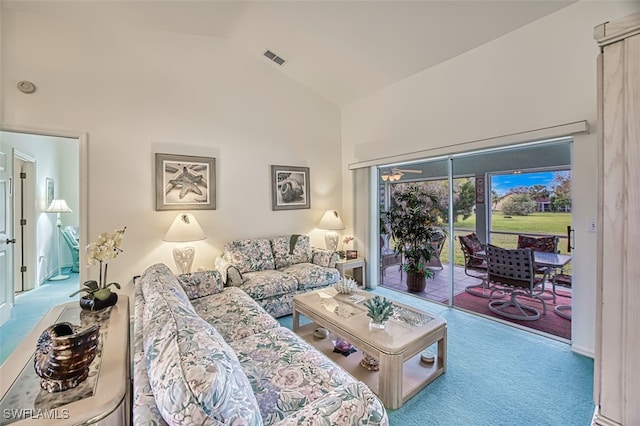 carpeted living room featuring high vaulted ceiling