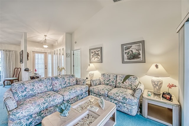 living room featuring carpet flooring, vaulted ceiling, and french doors