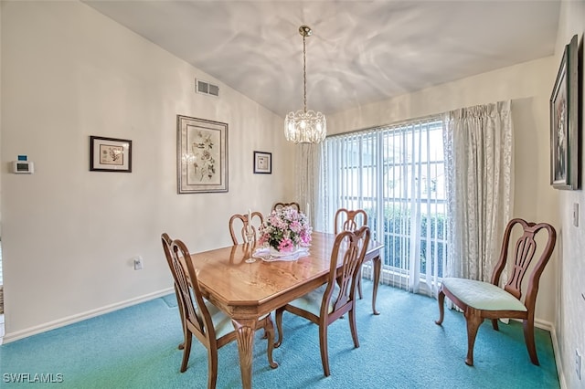 carpeted dining room with a chandelier and vaulted ceiling