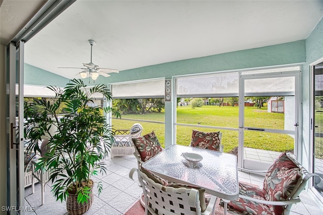 sunroom / solarium featuring ceiling fan and lofted ceiling