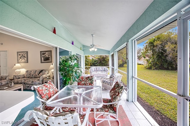 sunroom featuring ceiling fan and lofted ceiling