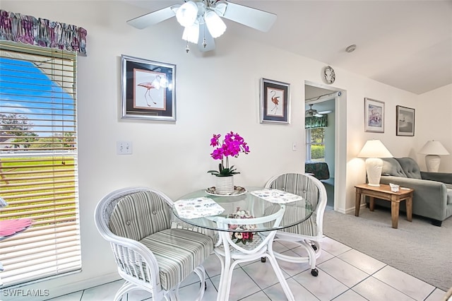 tiled dining space featuring ceiling fan