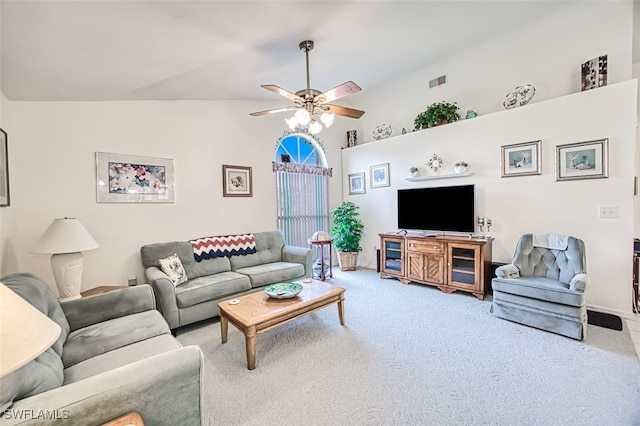 carpeted living room featuring ceiling fan and vaulted ceiling