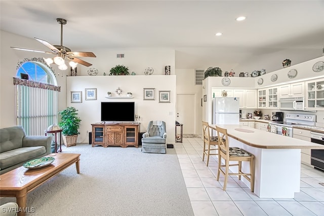 living room featuring ceiling fan and light tile patterned flooring