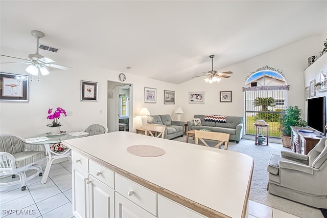 kitchen featuring white cabinets, ceiling fan, and light tile patterned floors