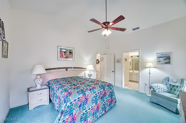 carpeted bedroom featuring ensuite bath and ceiling fan