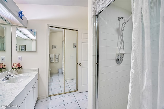 bathroom with tile patterned flooring, a shower, vanity, and toilet