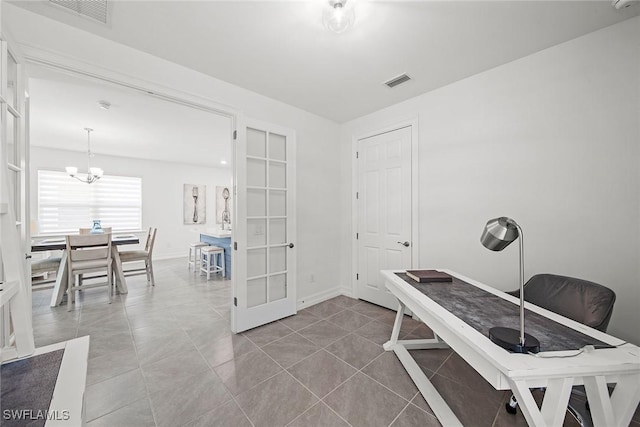 home office featuring an inviting chandelier, tile patterned flooring, and french doors