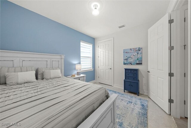 bedroom with light tile patterned floors