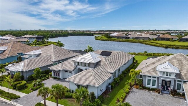 birds eye view of property with a water view and a residential view