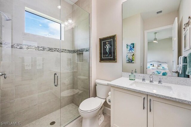 bathroom with toilet, vanity, and walk in shower