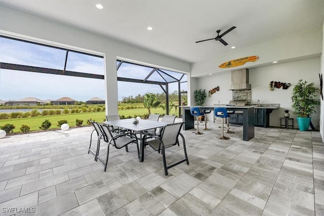 view of patio / terrace with an outdoor kitchen, an outdoor bar, and ceiling fan