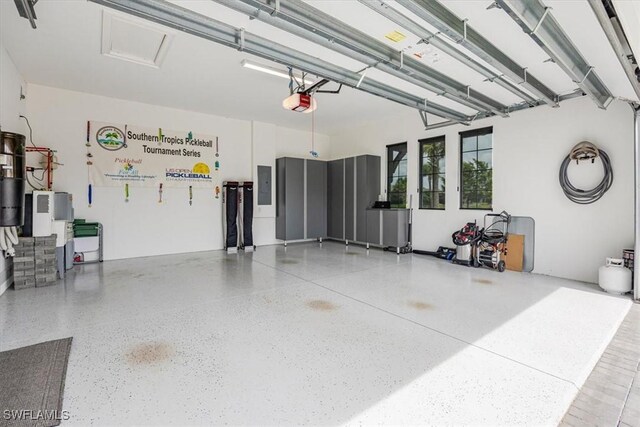 garage with electric panel and a garage door opener