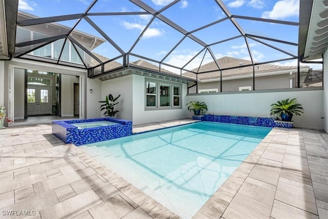 view of pool featuring glass enclosure, an in ground hot tub, french doors, and a patio