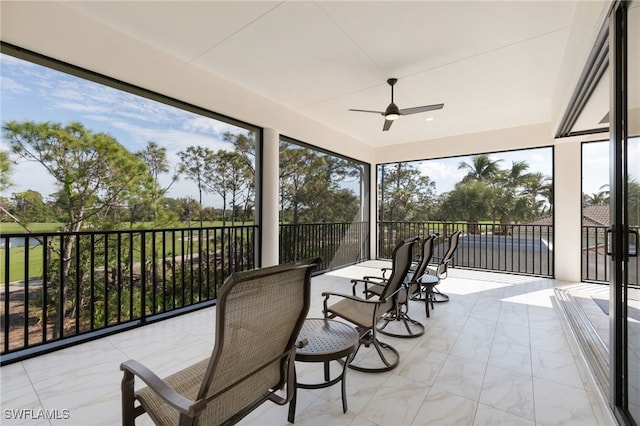 sunroom / solarium with ceiling fan