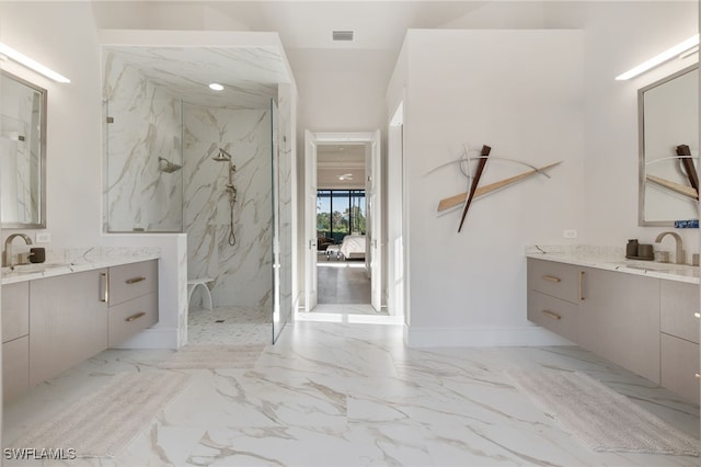 bathroom featuring a tile shower and vanity