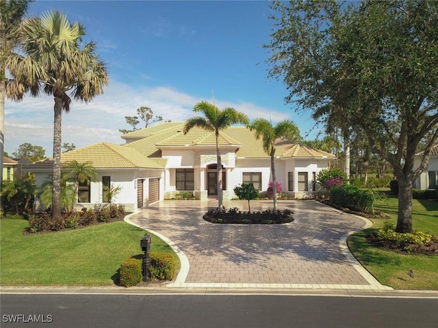 mediterranean / spanish house with a front yard