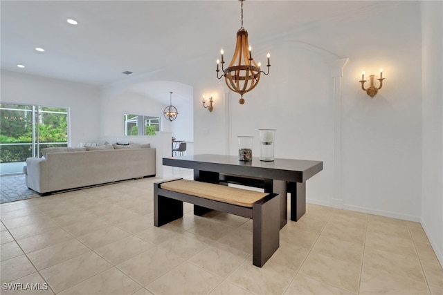 dining area featuring an inviting chandelier and light tile patterned flooring