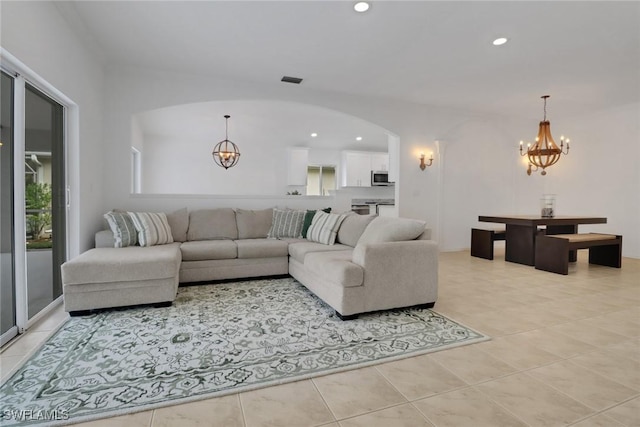 living room with an inviting chandelier and light tile patterned floors