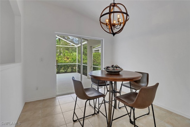 tiled dining room featuring a chandelier and vaulted ceiling