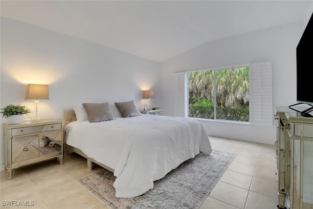 tiled bedroom featuring lofted ceiling