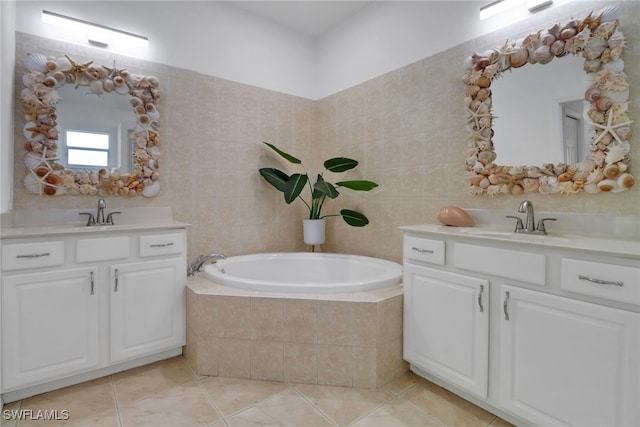 bathroom with vanity, tiled tub, tile patterned floors, and tile walls