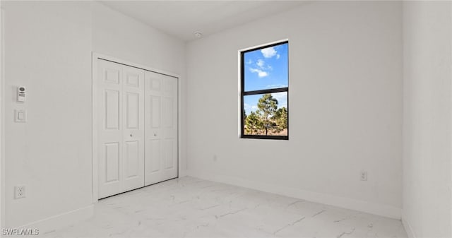 unfurnished bedroom with a closet