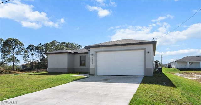 view of front of house with a front yard and a garage