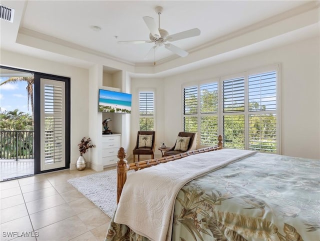 bedroom featuring ceiling fan, a raised ceiling, light tile patterned floors, and access to outside