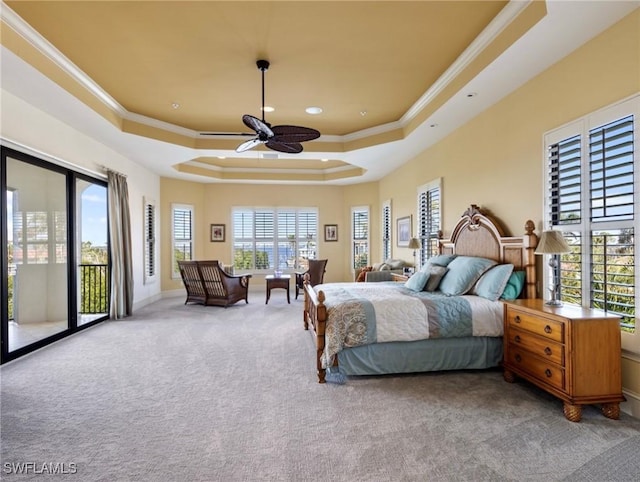 carpeted bedroom with a tray ceiling, ceiling fan, crown molding, and access to outside