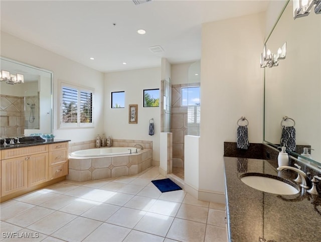 bathroom with tile patterned flooring, vanity, and independent shower and bath