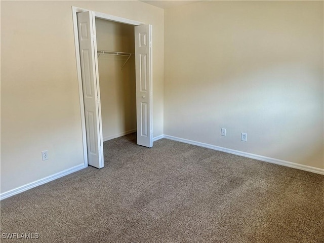 unfurnished bedroom featuring a closet and carpet floors